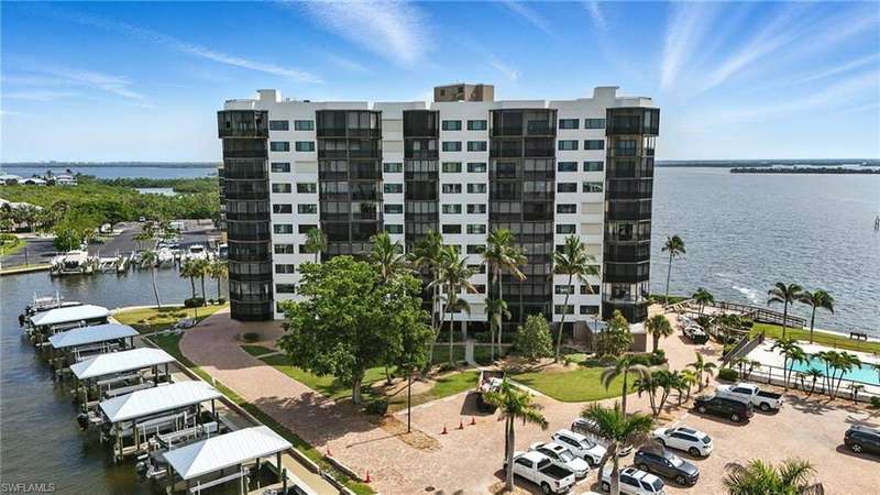 View of apartment building / complex featuring a water view