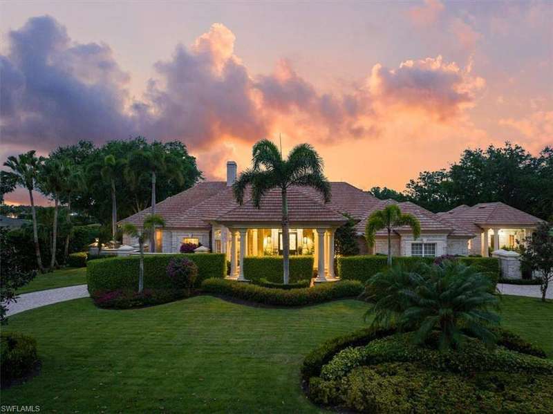Mediterranean / spanish-style home featuring a front yard and a chimney