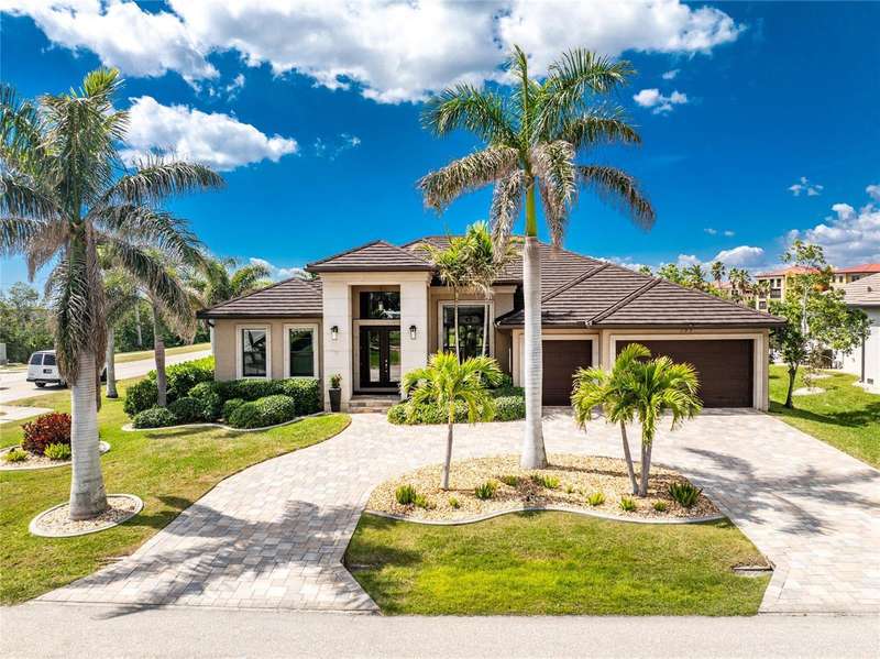 Brick paver circular driveway with 3-car garage.