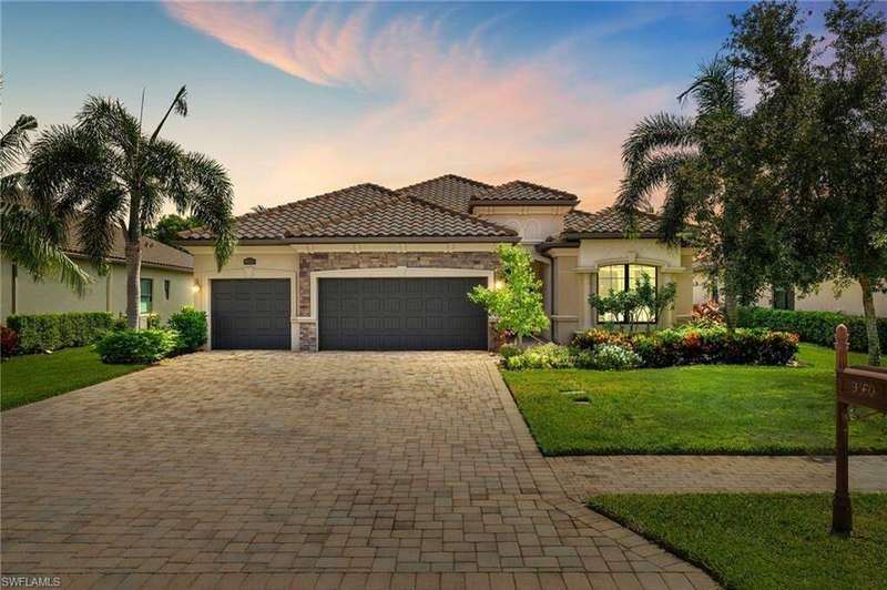 Mediterranean / spanish-style house with a lawn and a garage