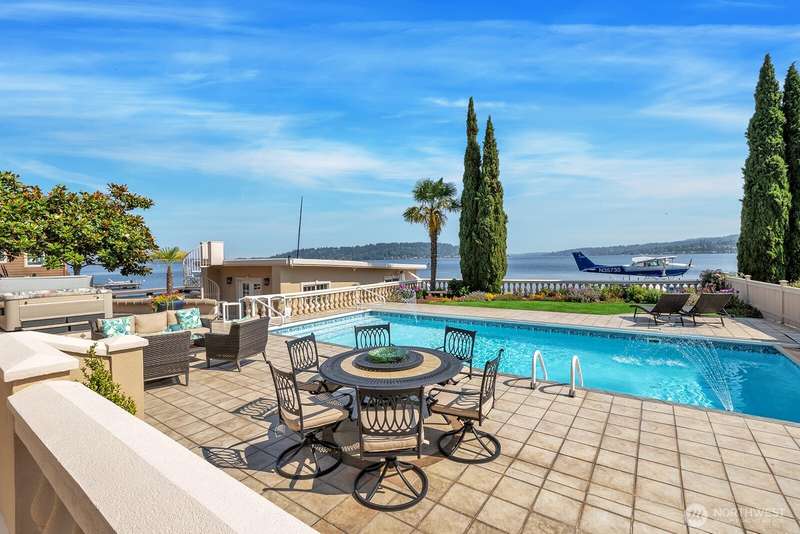Lakefront views with an in-ground pool and hot tub. Boat house with spiral staircase leading to the helipad.