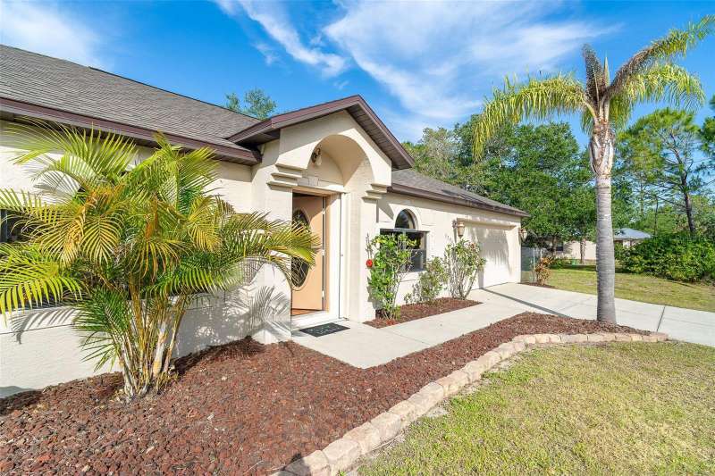 Easy care landscaping, accordion shutters on the front door