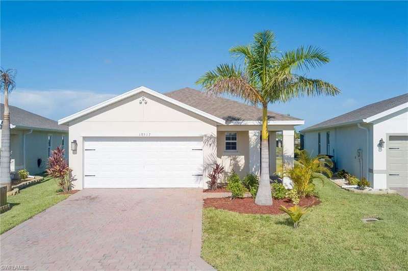 Single story home featuring stucco siding, decorative driveway, and an attached garage