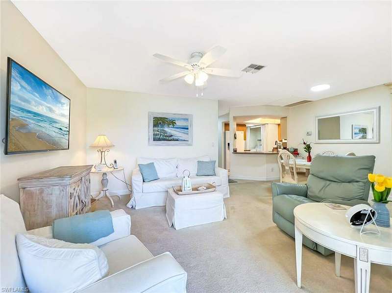 Living room with carpet flooring and ceiling fan