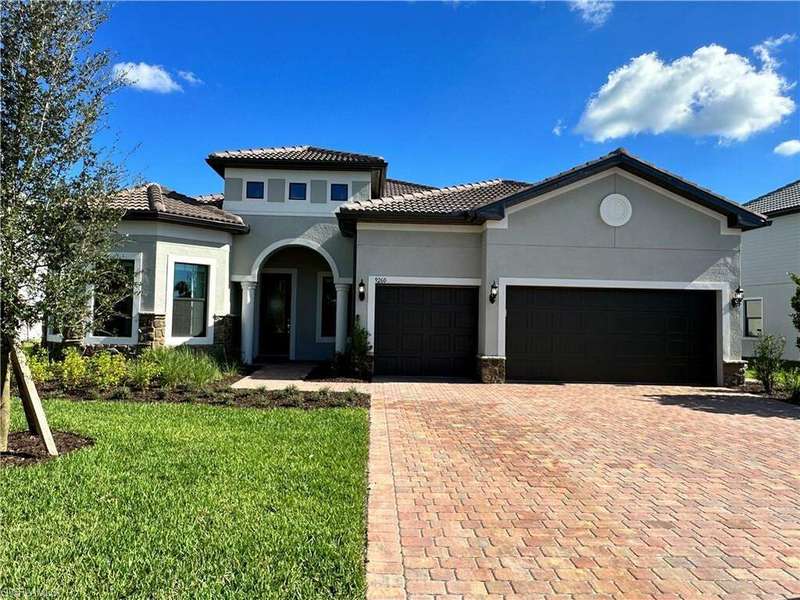 Mediterranean / spanish house featuring a garage and a front lawn