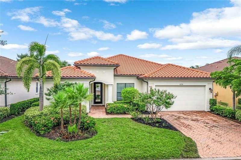 Mediterranean / spanish-style home with a garage and a front yard