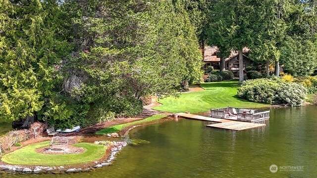 Frank Lloyd Wright inspired Pine Lake home on nearly an acre features 118' of waterfront. A year-round delight of stunning architecture and nature.