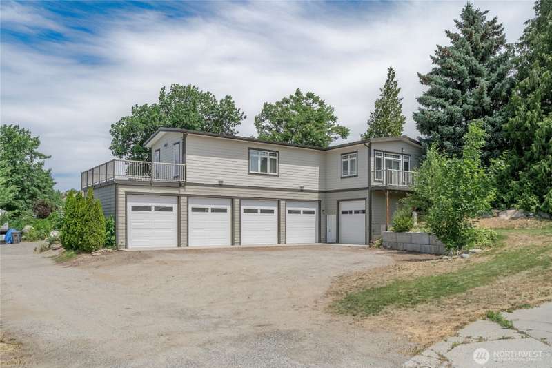 5 bay car garage, modern cement board siding, dual decks and patios and two story design with living quarters on top