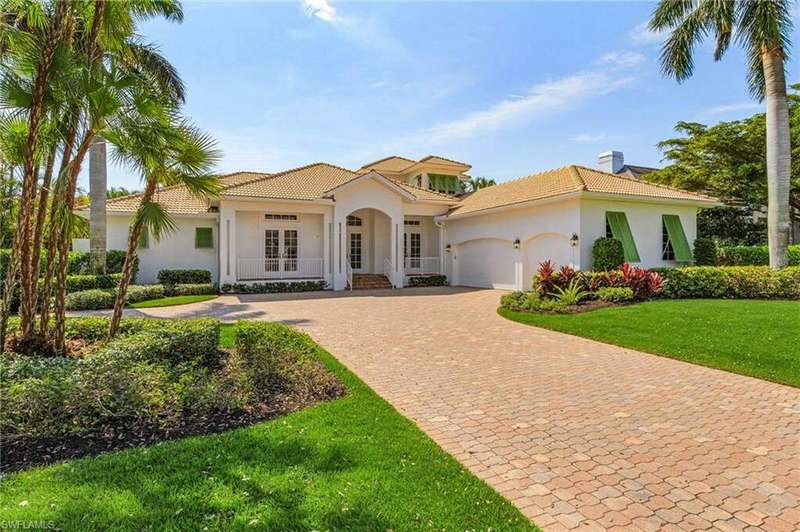 Mediterranean / spanish house featuring a front yard and a garage