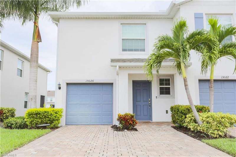 View of front of house with a garage, stucco siding, and decorative driveway