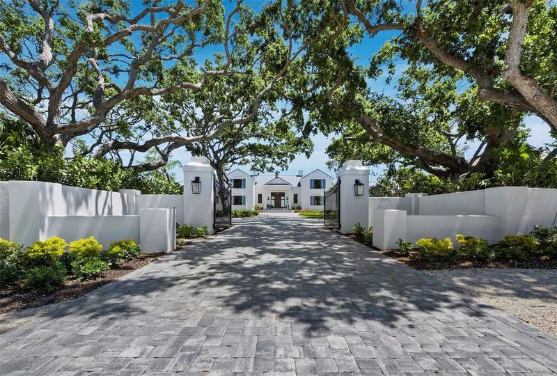 Extensive landscape lighting showcases the property beautifully at twilight.