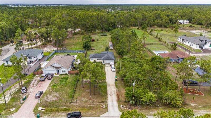 Aerial perspective of suburban area with a heavily wooded area