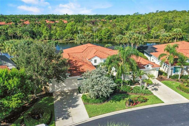 Birds eye view of property with a water view