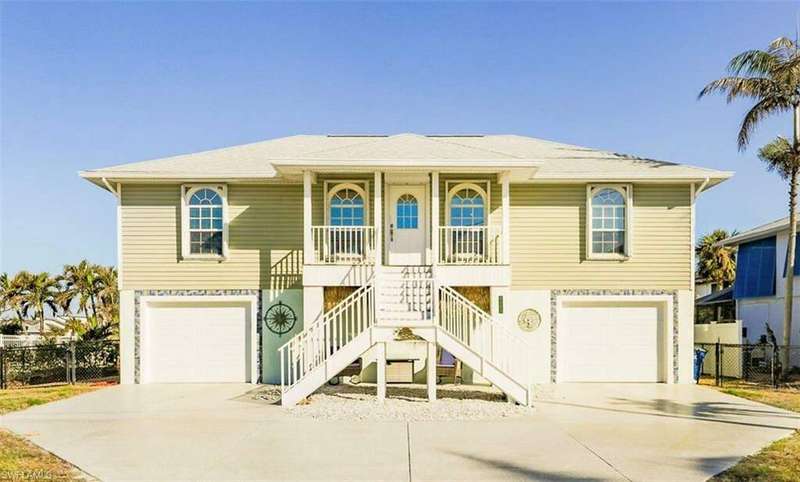 Beach home with a porch and a garage