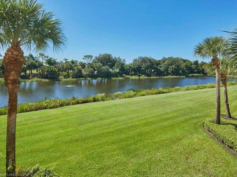 View of community featuring a lawn and a water view