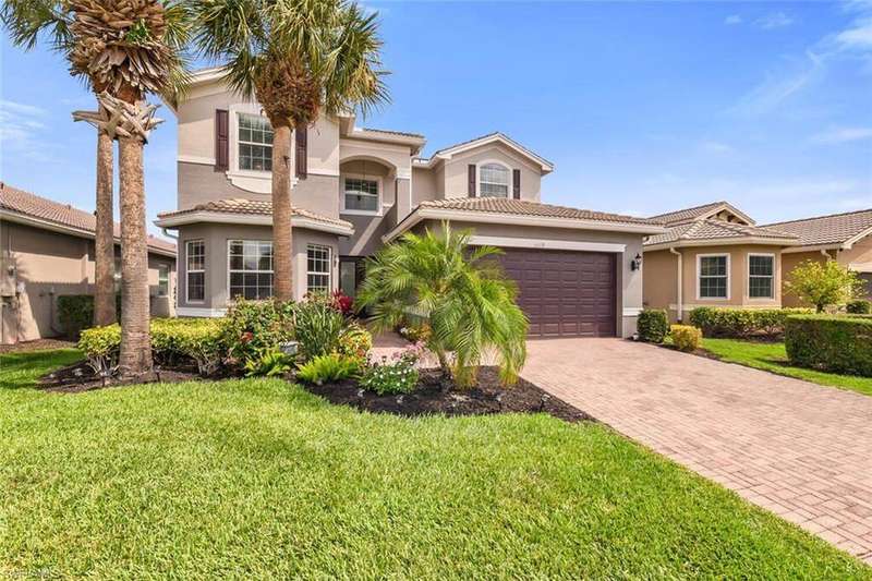 Mediterranean / spanish home with stucco siding, decorative driveway, a garage, and a front yard