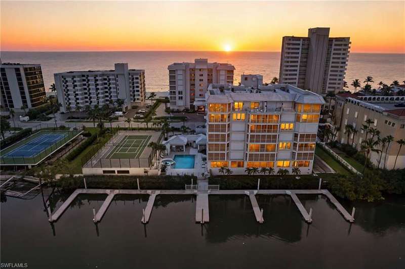 Drone / aerial view of a large body of water and a pool