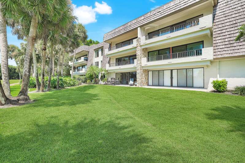 Living and Dining rooms looking out to private Lanai and the 12th Fairway.