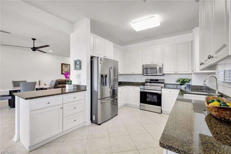 Beautiful clean and light kitchen with white shaker cabinetry and stainless steel appliances!