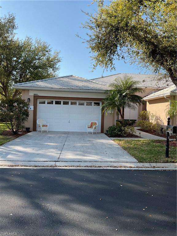 View of front of property with concrete driveway, an attached garage, and stucco siding