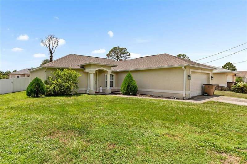 Ranch-style home featuring a garage, stucco siding, concrete driveway, and a shingled roof