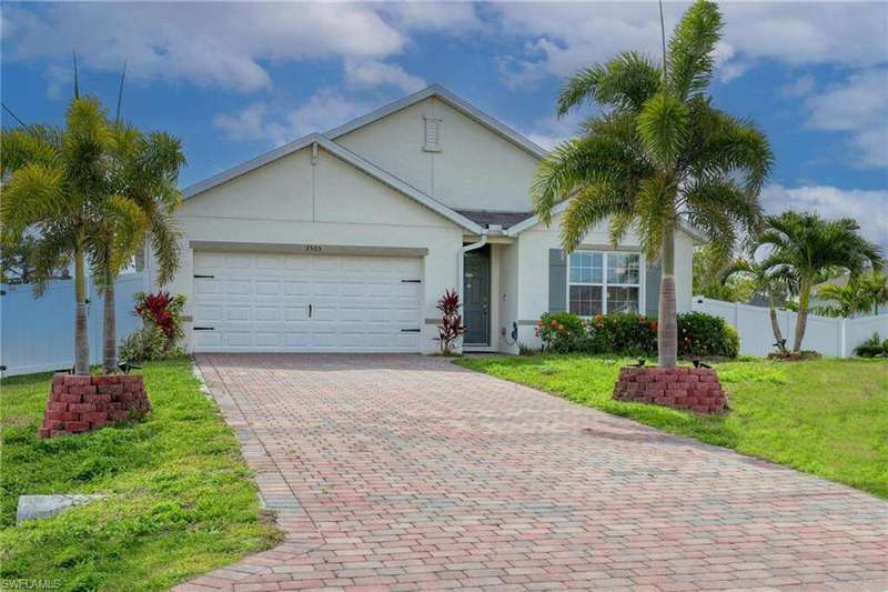 View of front of property with stucco siding, an attached garage, and decorative driveway