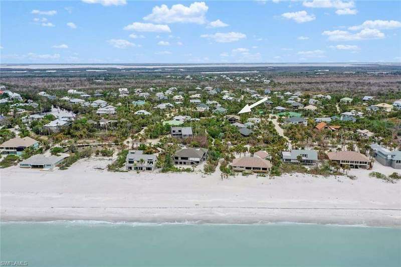 Aerial view of property and private beach