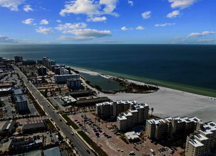 Aerial view featuring a water view and a beach view