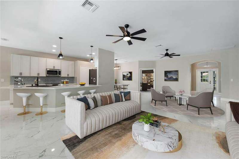 Living room featuring french doors, ceiling fan, and light tile flooring