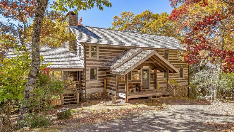Step into a world of rustic charm with this antique log home, uniquely positioned to offer breathtaking views of the Blue Ridge Mountains.