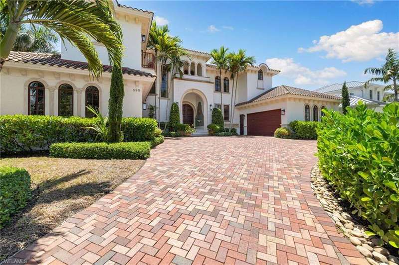 Mediterranean / spanish home with decorative driveway, an attached garage, stucco siding, and a tiled roof
