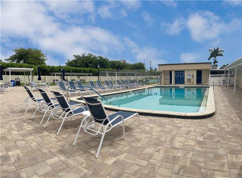 Community pool with a patio