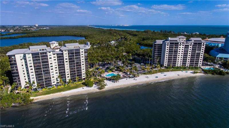 Drone / aerial view with a water view and a beach view