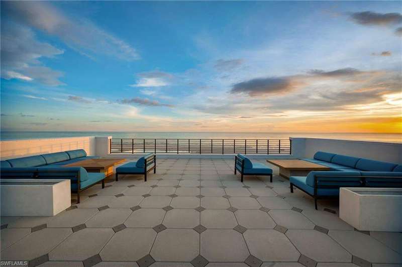 Patio terrace at dusk featuring a patio, an outdoor living space, and a water view