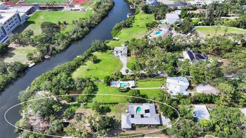 Sited on nearly 1 acre of desirable, elevated land along the serene shores of Phillippi Creek