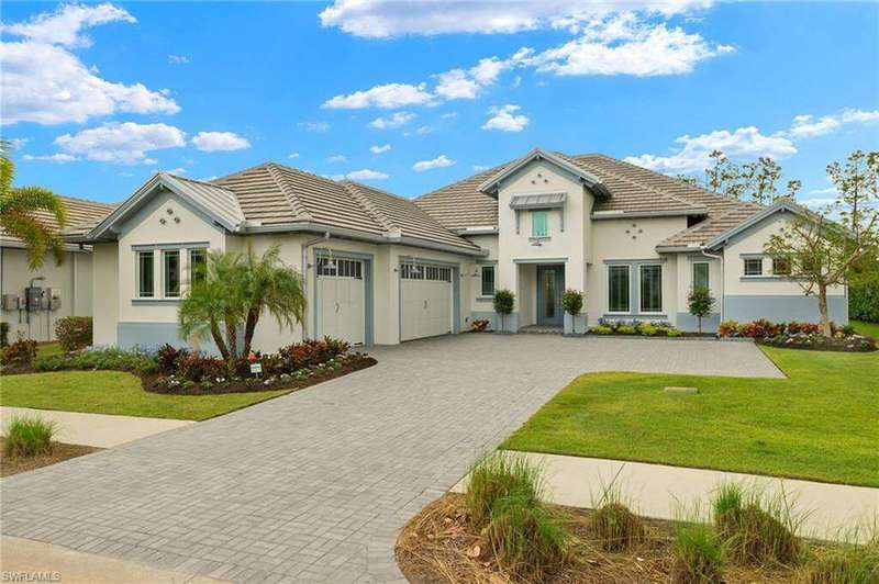 View of front of property with a garage and a front yard