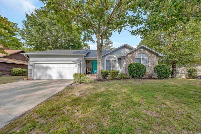 Ranch-style house with driveway, an attached garag