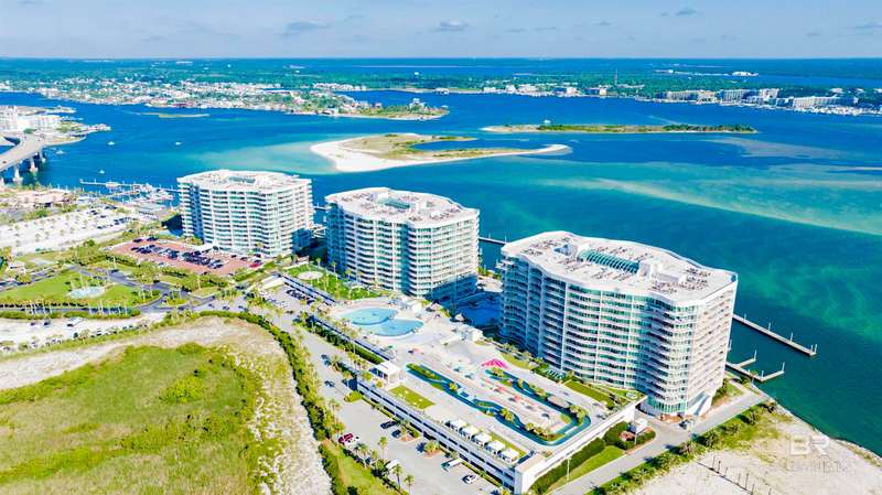 Birds eye view of property featuring a view of the beach and a water view