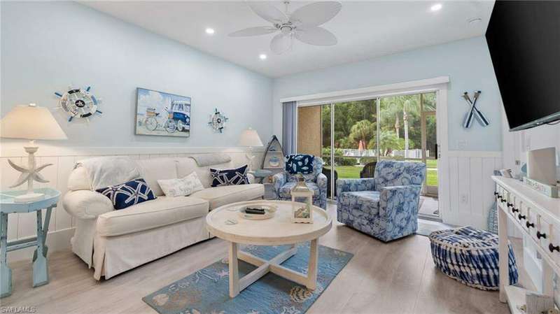 Living room with light hardwood / wood-style floors and ceiling fan