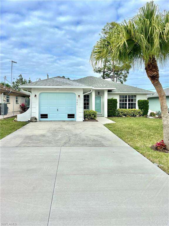 Single story home with a front lawn and a garage
