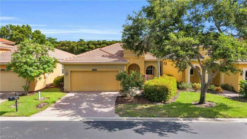 Mediterranean / spanish house with a garage and a front yard