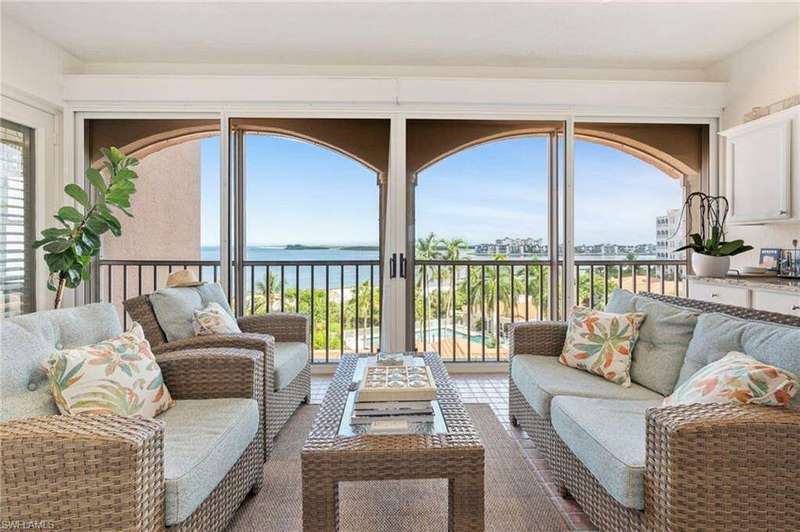 Living room with a wealth of natural light and a water view