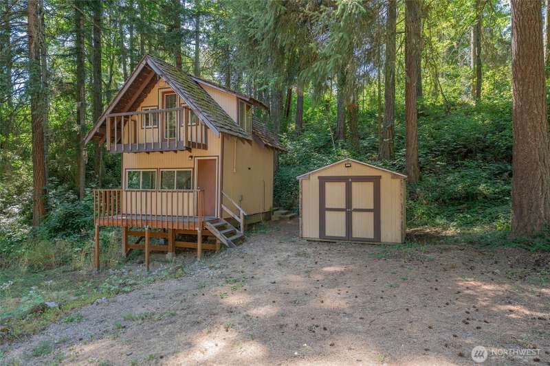 Front of cabin with storage shed.