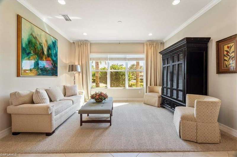 Carpeted living area featuring ornamental molding, recessed lighting, and tile patterned flooring