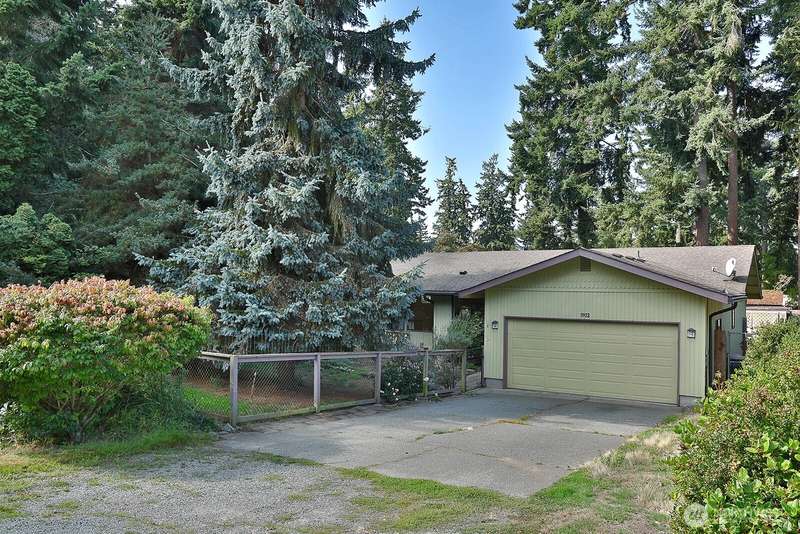 Two car garage and a private front yard greet you. Entrance is through the gate to the left of the garage. Your front yard is private with the row of trees that stand tall between you and Mountain View Lane.