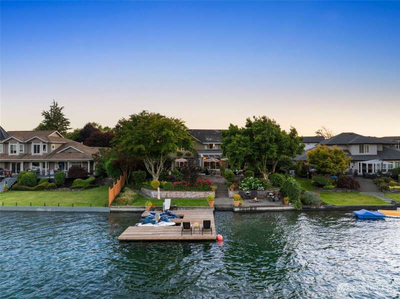 Rare 70ft of eastern facing waterfront. This oversized doc offers 2 jet ski lifts & room for boat parking. Spectacular Mt Rainier views w/swim area, bulkhead, firepit, many entertaining spaces & more!