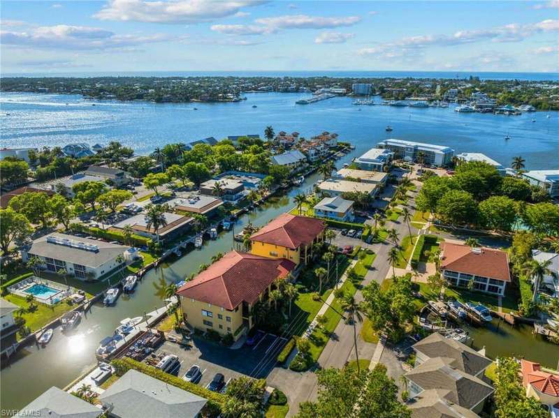 Birds eye view of property with a water view