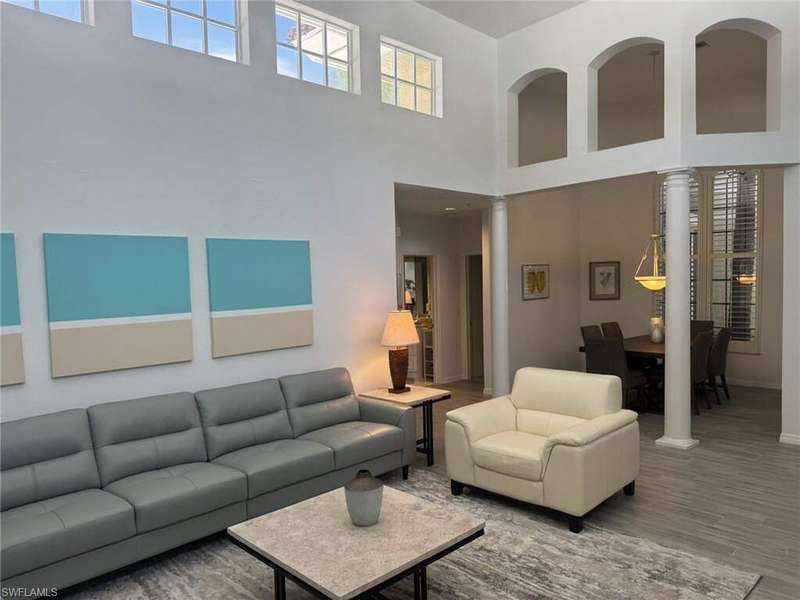 Living room with wood finished floors and a high ceiling
