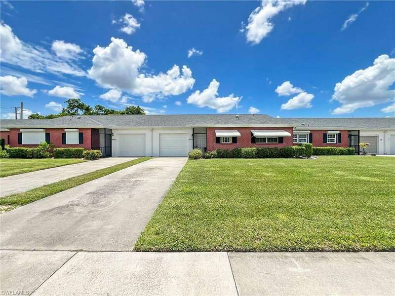 Ranch-style home with a garage and a front lawn