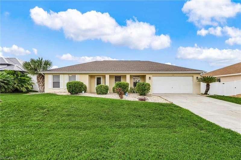 Single story home featuring stucco siding, driveway, and an attached garage